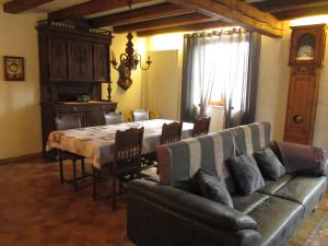 ein Wohnzimmer mit einem Sofa und einem Tisch in der Unterkunft Gite Chez Jean in Saint-Hippolyte