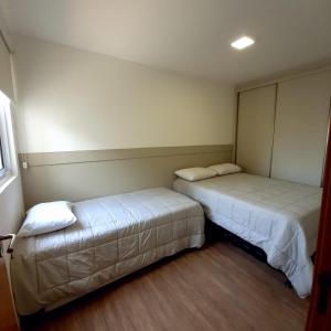 a room with two beds in a room at Mar com Diversão in Barra Velha