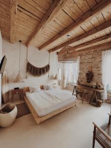 a bedroom with a large bed and a wooden ceiling at LISSA home in Vis