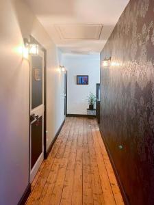 an empty hallway with a wooden floor and a wall at Room in Guest room - Les Chambres De Vilmorais - Violette Prince 