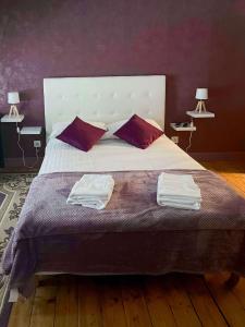 a bedroom with a large bed with two towels on it at Room in Guest room - Les Chambres De Vilmorais - Violette Prince 
