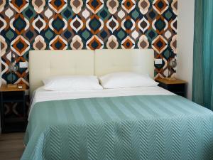 a bedroom with a bed with a patterned wall at VILLA MARIANNA in Marotta +55 photos