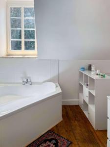 a white bathroom with a tub and a window at Room in Guest room - Vilmorais Rooms 
