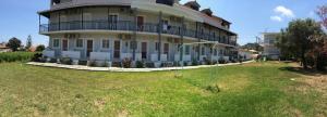 a large building with a large yard in front of it at Athina Studios in Argasi