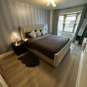 a bedroom with a large bed and a large window at One Bedroom Flat Town Centre Colchester in Colchester