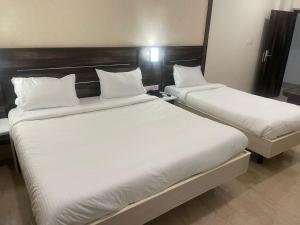 Postel nebo postele na pokoji v ubytování Avenue 11 Premium Stays Madurai