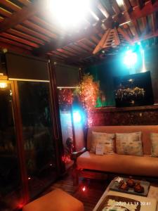 a living room with a couch in a room with lights at Marbella Beach îlot 5 in Mansouria