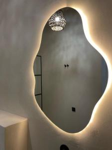 a room with a large oval mirror on the wall at LISSA home in Vis