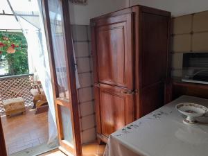 a kitchen with a large wooden cabinet next to a window at Il Casale degli Artisti in Ravigliano