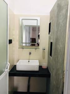 a bathroom with a sink and a mirror at Roshan Villa in Weligama