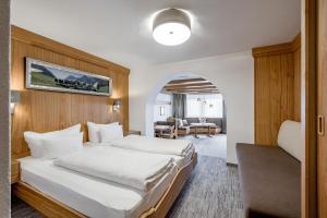 a bedroom with a bed and a living room at Apart Hotel Garni Wieser in Sölden