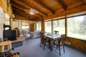 a living room with a table and a couch at Conconully Cabin on 42 Private Acres Near Hiking! in Conconully