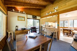 a dining room with a wooden table in a house at Conconully Cabin on 42 Private Acres Near Hiking! in Conconully