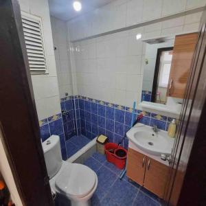 a blue and white bathroom with a toilet and a sink at 1+1 Flat in Fatih Aksaray in Istanbul