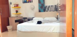 a bedroom with a bed with a hat on it at Marina's Rooms in Larnaca