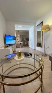a living room with a glass table in a room at Apartman Lalica in Split