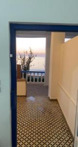 an open door with a view of the ocean at Inviting 1-Bed Apartment in Ksar sghir in Ksar es Sghir