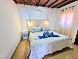 een slaapkamer met een bed met een blauwe badjas bij Casa Rural Giovanni & Rosa B Icod de los Vinos by HRTenerife Net in Icod de los Vinos