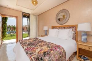 a bedroom with a bed and a large window at Villa Dar Laila in Marrakech