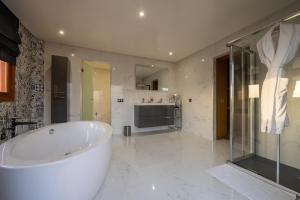 a large bathroom with a tub and a kitchen at Villa Dar Laila in Marrakech