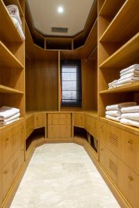 a walk in closet with wooden cabinets and a window at Villa Dar Laila in Marrakech