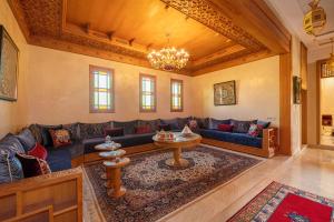 a living room with a blue couch and a table at Villa Dar Laila in Marrakesh
