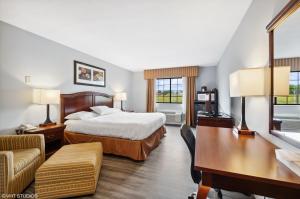 a hotel room with a bed and a desk at My Hometown Inn in Mooresville