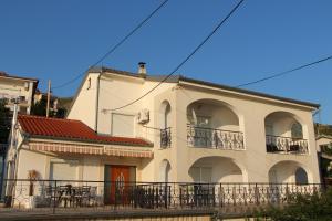 a white building with a balcony on the side of it at MARIAS in Senj