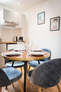 un tavolo in legno con bicchieri da vino sopra di L'Albatros 009 - Hypercentre * Cosy * Wifi a Saint-Quentin