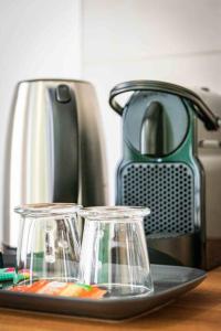 a counter with a toaster and two glass votives at L'Albatros 009 - Hypercentre * Cosy * Wifi in Saint-Quentin