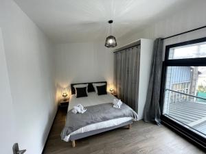 - une chambre avec un lit et une grande fenêtre dans l'établissement Superbe loft lumineux à Caen, à Caen