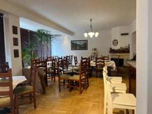 a dining room with tables and chairs in a restaurant at SOHO Green Pristina Kosovo in Pristina +75 photos