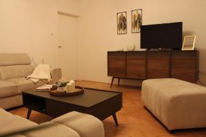 a living room with a couch and a tv at MARIAS in Senj