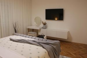 a bedroom with a bed and a tv on a wall at MARIAS in Senj +32 photos