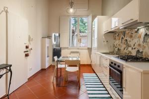 a kitchen with a table and a stove top oven at Classic Loft by Mmega in Florence +5 photos