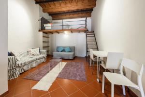 a living room with a loft bed and a table and chairs at Classic Loft by Mmega in Florence