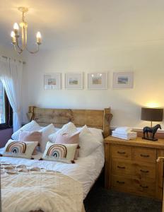 a bedroom with a bed and a desk with a lamp at Stunning quirky home in Amble in Amble