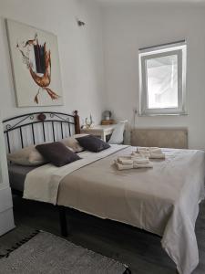 a bedroom with a large bed with towels on it at Villa Molo in Novigrad Istria