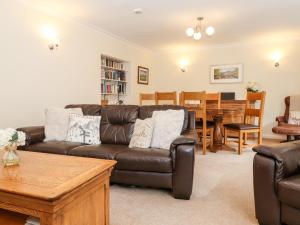 a living room with a couch and a table at Holly Cottage in Ambleside