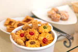 a bowl of food on a table with plates of food at Hotel Nettuno in Ischia