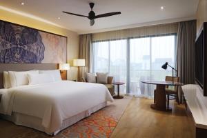 a bedroom with a large bed and a large window at The Westin Desaru Coast Resort in Desaru