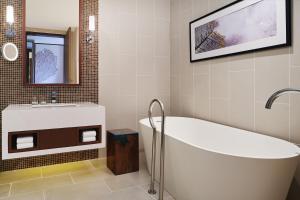 a bathroom with a tub and a sink at The Westin Desaru Coast Resort in Desaru