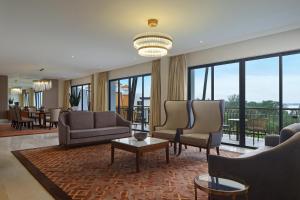 a living room with couches and chairs and a table at The Westin Desaru Coast Resort in Desaru