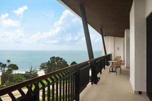 a balcony with a view of the ocean at The Westin Desaru Coast Resort in Desaru