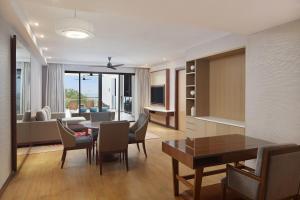 a living room with a table and chairs and a couch at The Westin Desaru Coast Resort in Desaru