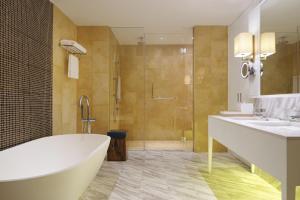 a bathroom with a large tub and a shower at The Westin Desaru Coast Resort in Desaru