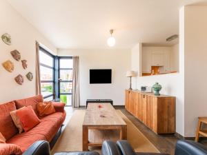 a living room with a couch and a table at Charming apartment in Zeeland with beautiful sea view in Cadzand-Bad