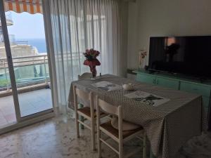 a dining room with a table with a view of the ocean at 1 meter from Monaco. 5 min by elevators to Larvotto beach. in Beausoleil