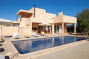 a villa with a swimming pool and a house at Ca na Catalina in Sant Jordi