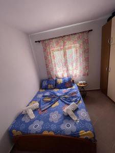a bedroom with a bed with two stuffed animals on it at Vila Du Lac Blue in Pogradec